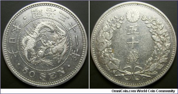 Japan 1898 50 sen. Ribbons up variety which is more common. Nice condition unfortunately cleaned. Weight: 13.43g.